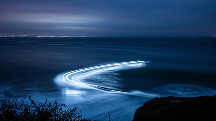 Long-exposure shot of a surfer leaving a light trail as they maneuver a night wave