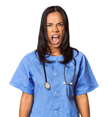 Young Filipina nurse posed in studio screaming very angry and aggressive.