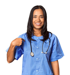 Young Filipina nurse posed in studio person pointing by hand to a shirt copy space, proud and confident