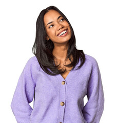 Young Filipina with long black hair in studio relaxed and happy laughing, neck stretched showing...