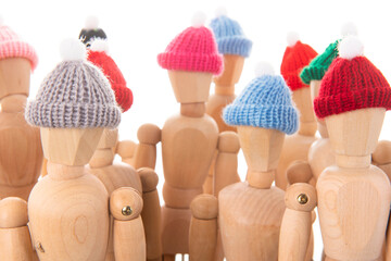 Crowd wooden mannequins with winter hat