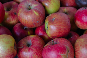Red apples background. Red ripe apple fruits in the market. Winter harvest. Sweet juicy fruits. Garden harvest. Raw food. 