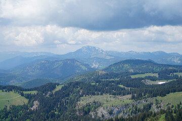 Fototapeta premium Idyllic panoramic view: Small green hills and steep snowy mountains in Ötscherland, Lower Austria