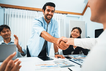 Diverse group of office employee worker shake hand after making agreement on strategic business...