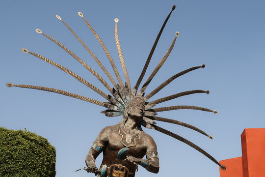 A statue of a dancing warrior of the Chichimeca/El Danzante Conchero Chichimeca in the city center of Queretaro, Mexico