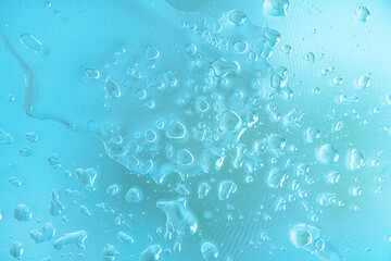 abstract background of water and oil droplets on glass texture in turquoise tones