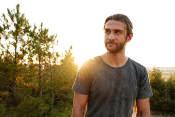 Casual man hiker outdoors in gray T-shirt outdoors portrait