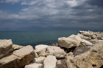 Fototapeta na wymiar Stones on the coast of the Ionian sea, Roda, Corfu