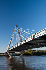 Low angle view of suspension bridge towering over river