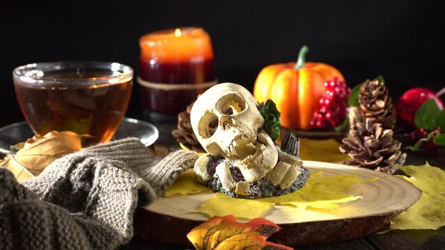 Halloween symbols are a skull, pumpkins and flickering candles. Perfect for Halloween lovers and captures the essence of the season's traditions and creates a spooky yet festive atmosphere.
