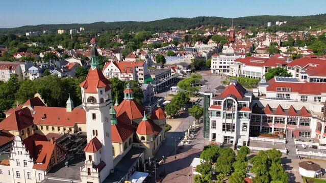 Sopot Lighthouse, aerial view. Establishing shot of famous seaside resort with luxury architecture and long pier, by the Baltic sea in Poland. Sunny summer day in a Baltic city. 