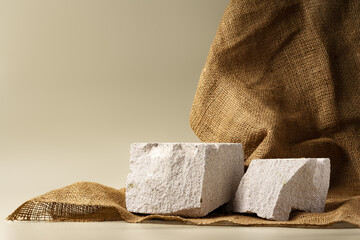 Granite stone podium decorated with sackcloth on beige background