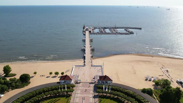 Sopot city in Poland, aerial view. Establishing shot of famous seaside resort with luxury architecture and long pier, by the Baltic sea. Sunny summer day.