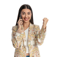 enthusiastic young woman talking on the phone and celebrating victory
