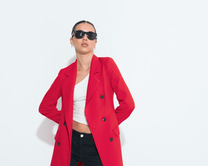 sexy young woman with sunglasses holding hands behind