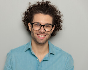 close up of sexy man with curly hair looking forward and smiling