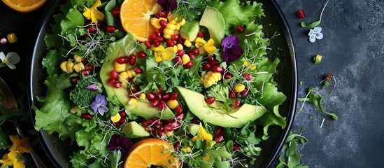 Poster Mixed salad with kale and broccoli microgreens, lettuce, corn, avocado, orange, pomegranate, and edible flowers. © TheWaterMeloonProjec