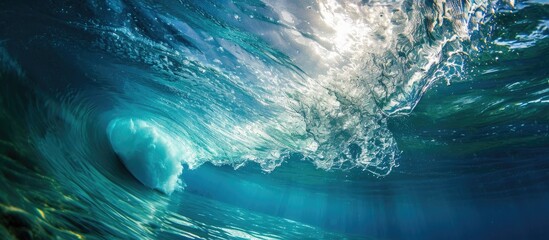Duck dive underwater beneath blue ocean's barrel wave.