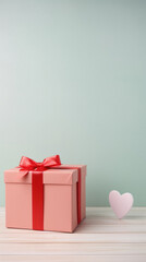 Gift box with red bow and heart on pastel color background.