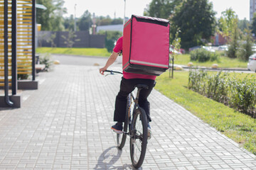 Courier on bicycle delivering food and drink in summer time