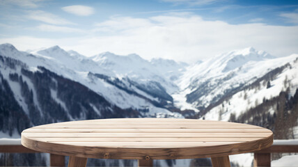 Empty wooden table to display products, round wooden table  in front of blurred snowy mountain background, winter packshot, beautiful nature in winter, switzerland, norway, alps