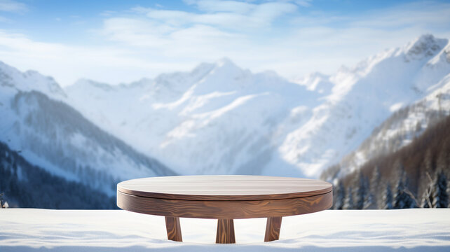 Empty wooden table to display products, round wooden table  in front of blurred snowy mountain background, winter packshot, beautiful nature in winter, switzerland, norway, alps