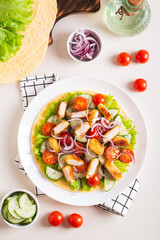 Tortilla with nuggets, vegetables and lettuce on a plate on the table top and vertical view