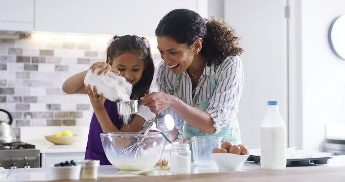 Home, baking and family with recipe, playing and love with happiness, activity and hobby. Mother, childhood and kid with mama, girl or utensils with ingredients, measurement cup and bowl in a kitchen