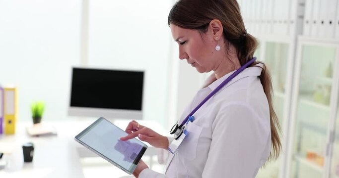 Cardiologist examines digital tablet with electrocardiogram in clinic