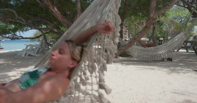 A young woman is laying in the beach hammock, Gili Meno, Indonesia
