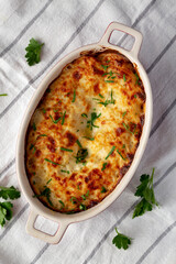 Homemade Scalloped Potatoes with Cheese and Parley, top view. Close-up.