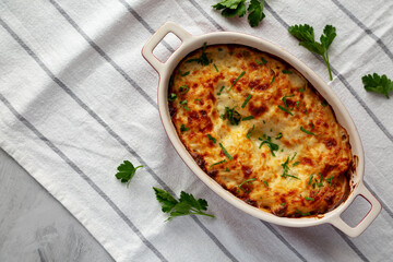 Homemade Scalloped Potatoes with Cheese and Parley, top view. Copy space.