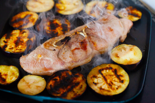 Close-up of delicious pork with eggplant frying on grill