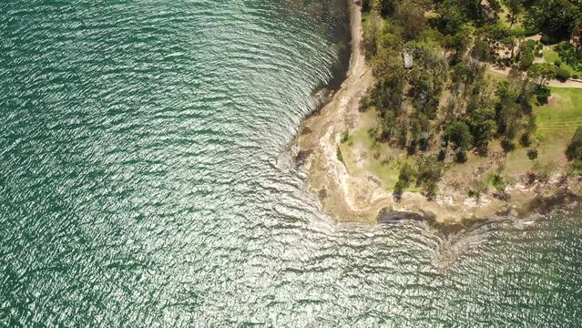 Murrays beach waterfront edge in aerial vertical panorama to Swansea – australia 4k.
