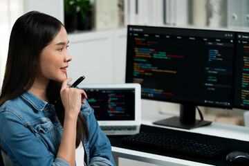 Young Asian IT developer looking online information on pc for beautiful pose with coding program...