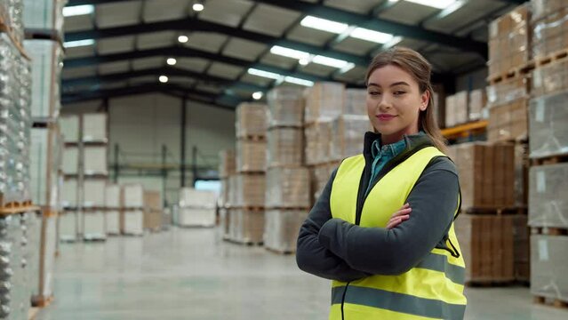 Female warehouse worker standing in warehouse. Warehouse manager checking delivery, stock in warehouse, inspecting products for shipment.