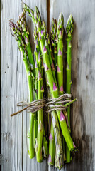 Fresh green asparagus bundle on rustic wood, farm-to-table, healthy eating.