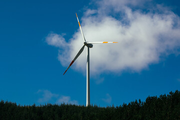 Slow motion fast video of  wind farm or wind park at sunset located in the mountains of Italy Europe and it allows to realize clean energy. It’s sustainable, renewable energy for enviromental. 