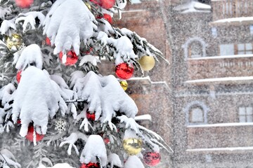 Decorated Christmas tree by winter under heavy snow