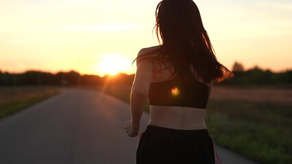silhouette sports girl running legs along road sunset, summer thailand, jogger, street evening,...