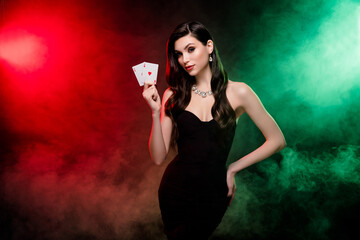 Photo of chic classy rich wealthy girl in neon private vip party over dark background risky winning in poker game