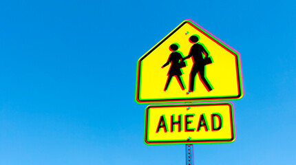 black on bright yellow crosswalk ahead sign against a blue sky, with glitch effect