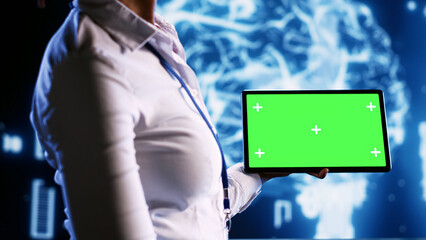 Admin in data center with chroma key tablet using artificial intelligence computing simulating human brain thought processes. African american expert working with AI neural network algorithms