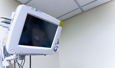 Hospital monitor displaying vital signs: heart rate, blood pressure, oxygen levels, crucial for patient health and medical assessment