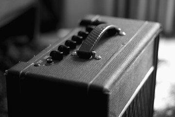 antique guitar amplifier, suitcase type, black and white photograph, musicians, bands, instruments