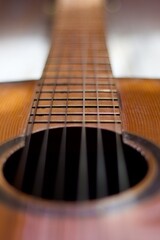 neck and headstock of an acoustic guitar on aged white wood, romantic, melancholic, solitary,...
