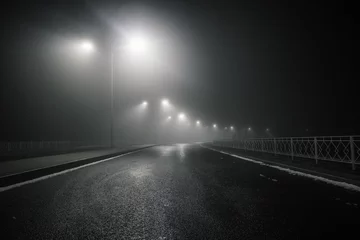 Fototapeten Foggy misty night road illuminated by street lights © Mulderphoto