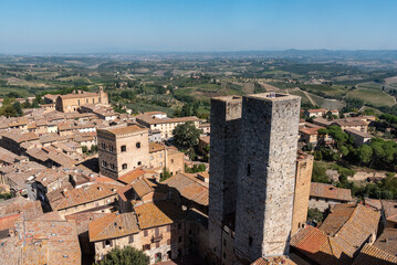 Fototapeta na wymiar Wide panoramic view over downtown San Gimignano, Torri dei Salvucci in the center, seen from Torre Grosso