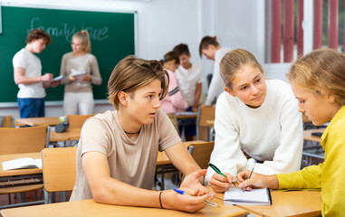 Schoolchildren study together in group lessons in the school class