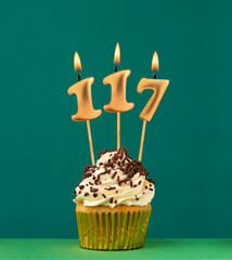 Birthday card with candle number 117 - Green background